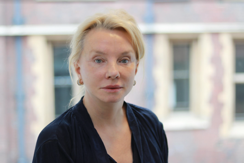 Headshot of Jennifer Donohue, a caucasian woman with blonde hair pinned up and blue eyes. 