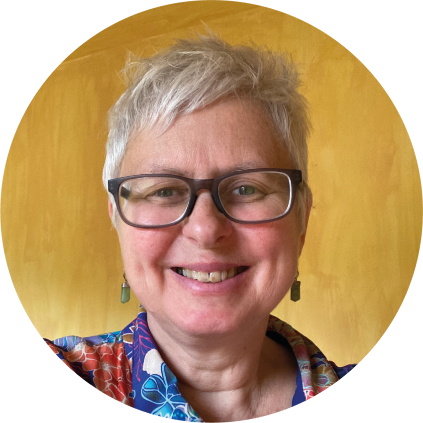 A headshot of smiling Dr Sue Bowler with a mustard yellow background.