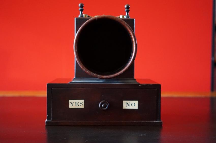 An image of a black ballot against a red background.