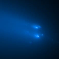 Image showing blue fragments of a comet breaking up