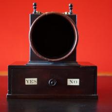 An image of a black ballot against a red background.