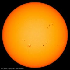 Image from the Solar Dynamics Observatory mission of the solar disk with multiple sunspots, which appear dark compared with their surroundings. Credit: HMI/SDO/NASA