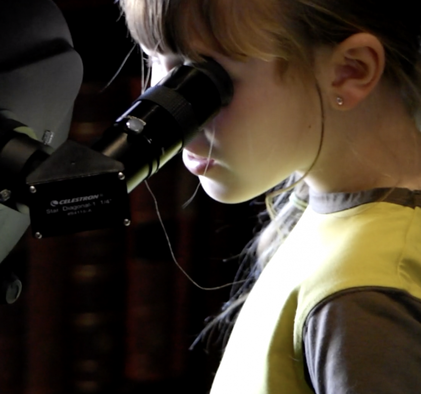 Brownie looking through a telescope